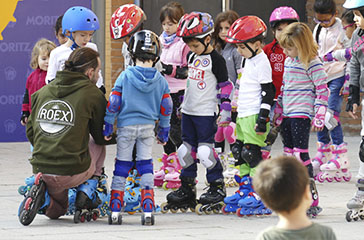 Patines en línea - Un grupo de niños escuchando al monitor de patinaje, todos con patines